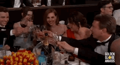random animated gif of a group of people toasting with champagne glasses